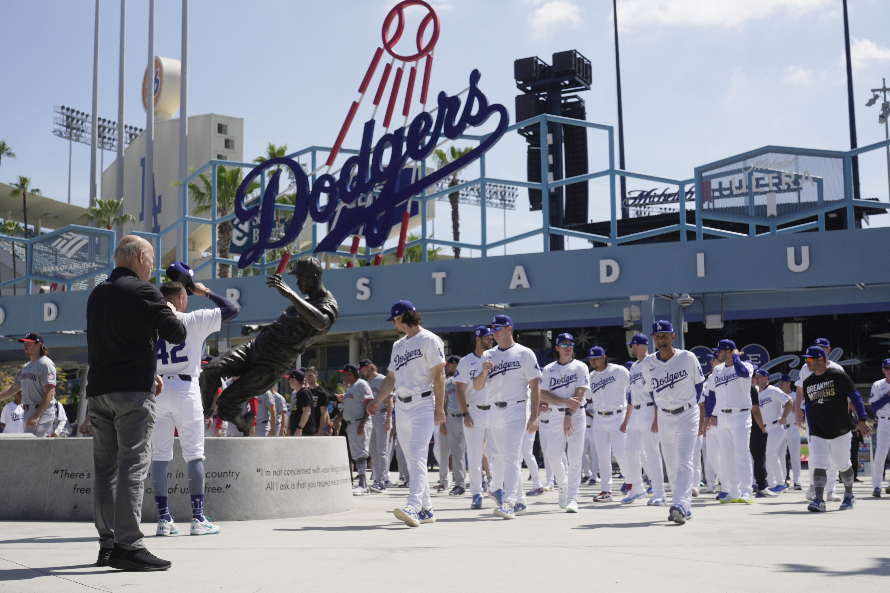 Los Angeles Dodgers and Washington Nationals team members arrive to celebrate Jackie Robinson Tribute Day before a baseball game at Dodgers Stadium in Los Angeles on Monday, April 15, 2024. (AP Photo/Damian Dovarganes)